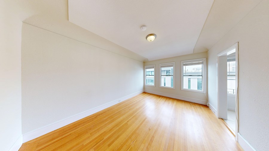 A room with wooden floors and white walls.